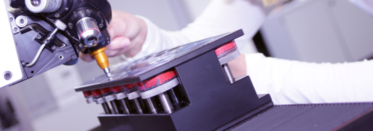 Employee Using a Hardness Tester Machine