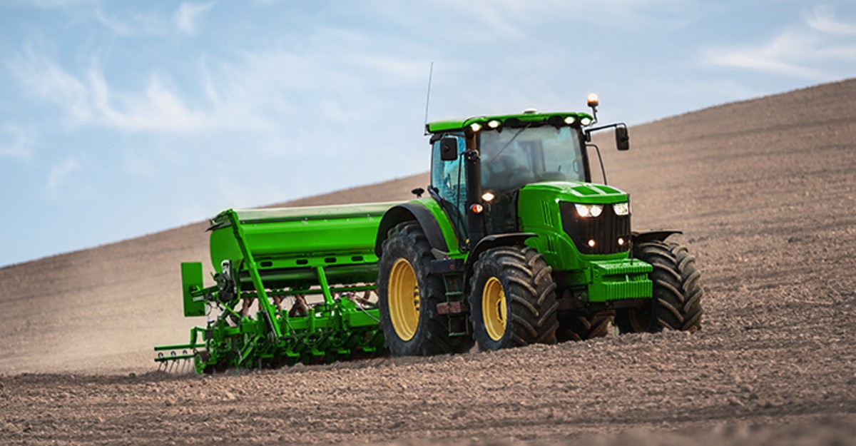 Green Tractor Plowing Field